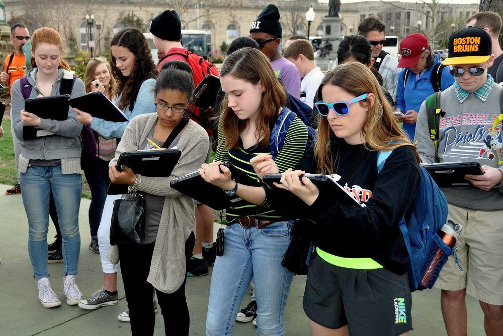 Students  use their tablets while on a field trip