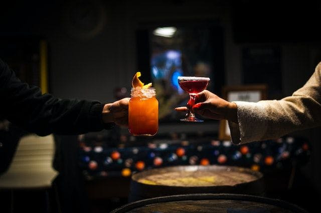 a couple toasting cocktails