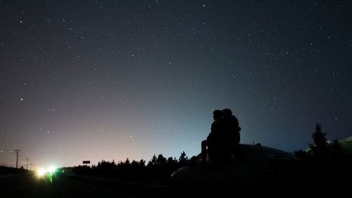 a man and woman stargazing