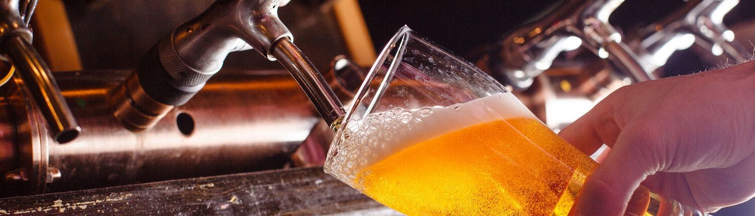 bartender pouring a draft beer
