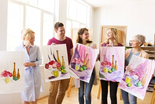 people showing their paintings