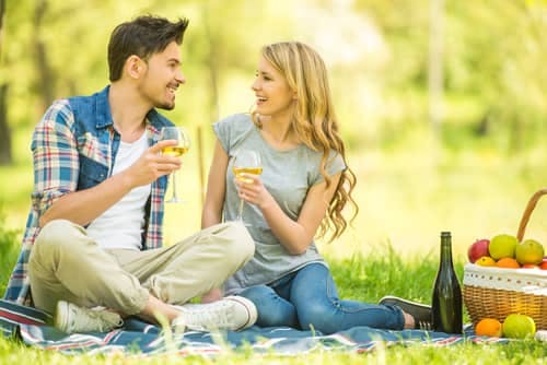 a man and woman having a picnic